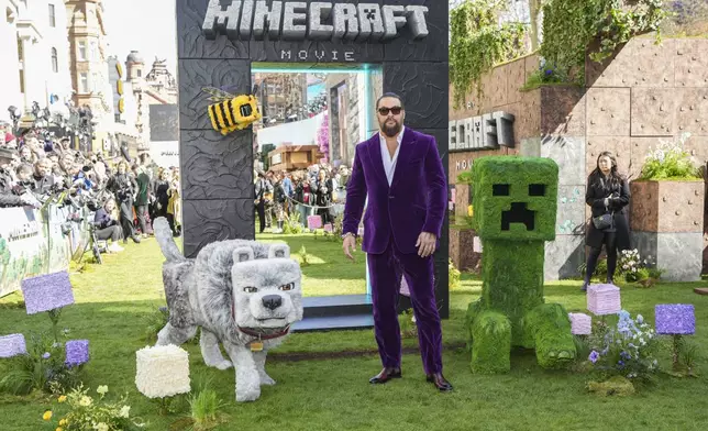 Jason Momoa pose for photographers upon arrival at the World premiere of A Minecraft Movie on Sunday, March 30, 2025, in London. (Photo by Scott A Garfitt/Invision/AP)
