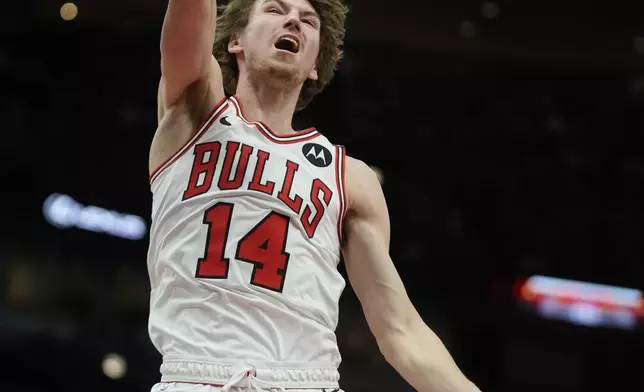 Chicago Bulls forward Matas Buzelis (14) dunks during the first half of an NBA basketball game against the Toronto Raptors, Friday, Feb. 28, 2025, in Chicago. (AP Photo/Erin Hooley)