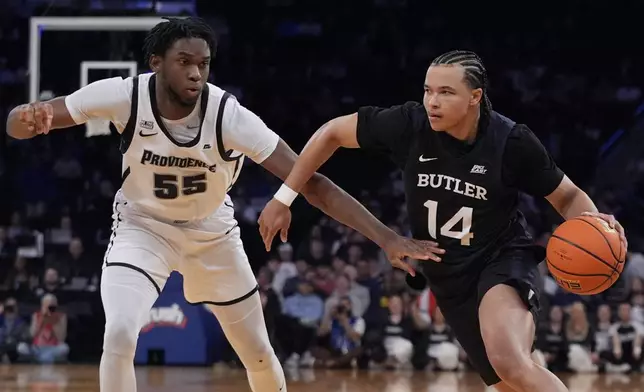 Butler's Landon Moore (14) drives past Providence's Oswin Erhunmwunse (55) during the second half of an NCAA college basketball game at the Big East basketball tournament Wednesday, March 12, 2025, in New York. (AP Photo/Frank Franklin II)