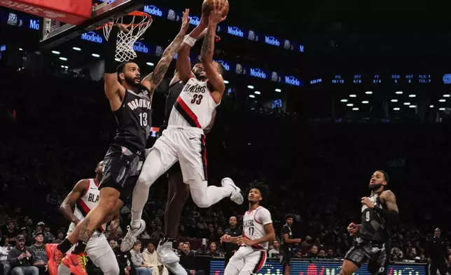 Brooklyn Nets' Tyrese Martin (13) defends Portland Trail Blazers' Toumani Camara (33) during the first half of an NBA basketball game Friday, Feb. 28, 2025, in New York. (AP Photo/Frank Franklin II)
