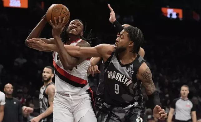 Brooklyn Nets' Trendon Watford (9) defends Portland Trail Blazers' Jabari Walker (34) during the first half of an NBA basketball game Friday, Feb. 28, 2025, in New York. (AP Photo/Frank Franklin II)
