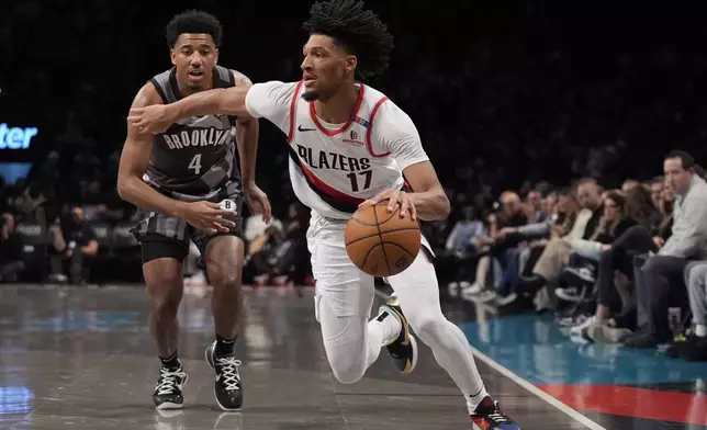 Portland Trail Blazers' Shaedon Sharpe (17) drives past Brooklyn Nets' Reece Beekman (4) during the first half of an NBA basketball game Friday, Feb. 28, 2025, in New York. (AP Photo/Frank Franklin II)
