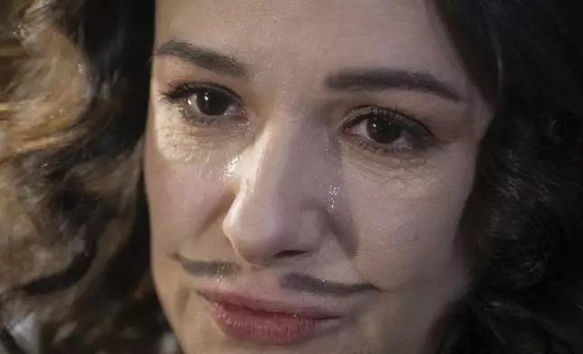 Actress Ruslana Ostapko, wearing a painted moustache, cries as the talks about her male colleagues who joined the Ukrainian army and were killed in Russia-Ukraine war, in the Chernihiv Regional Youth Theater in Chernihiv, Ukraine, Sunday, Feb. 16, 2025. (AP Photo/Efrem Lukatsky)