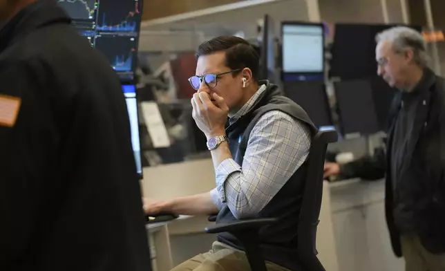 People work on the options floor at the New York Stock Exchange in New York, Tuesday, March 4, 2025. (AP Photo/Seth Wenig)