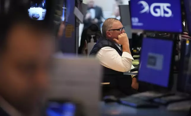 People work on the floor at the New York Stock Exchange in New York, Tuesday, March 4, 2025. (AP Photo/Seth Wenig)