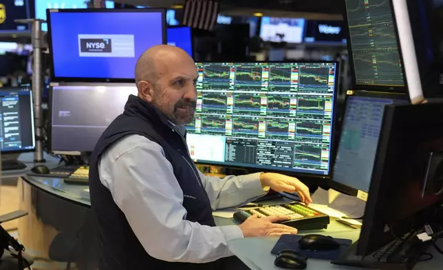 People work on the floor at the New York Stock Exchange in New York, Tuesday, March 4, 2025. (AP Photo/Seth Wenig)