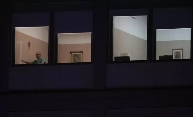 A man walks in the ward where Pope Francis is hospitalized at the Agostino Gemelli Polyclinic, in Rome, Italy, Sunday, March 2, 2025. (AP Photo/Andrew Medichini)