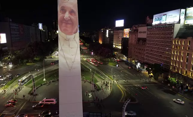 A photo of Pope Francis is projected on the Obelisk in Buenos Aires, Argentina, Saturday, Feb. 22, 2025. (AP Photo/Natacha Pisarenko)