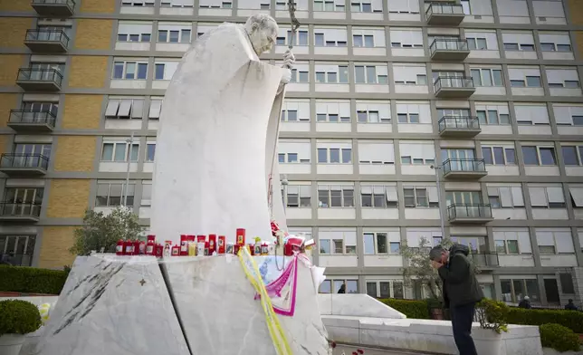 A man prays for Pope Francis in front of the Agostino Gemelli Polyclinic, in Rome, Saturday, March 8, 2025, where the Pontiff is hospitalized since Feb. 14. (AP Photo/Andrew Medichini)
