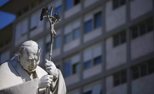 A statue of Pope John Paul II is seen in front of the Agostino Gemelli Polyclinic, in Rome, Thursday, March 6, 2025, where Pope Francis is hospitalized since Friday, Feb. 14. (AP Photo/Andrew Medichini)