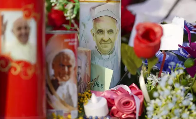 Candles and flowers for Pope Francis are seen in front of the Agostino Gemelli Polyclinic, in Rome, Sunday, March 2, 2025, where the Pontiff has been hospitalized since Friday, Feb. 14. (AP Photo/Andrew Medichini)