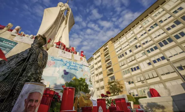 Candles and flowers for Pope Francis are seen in front of the Agostino Gemelli Polyclinic, in Rome, Sunday, March 2, 2025, where the Pontiff has been hospitalized since Friday, Feb. 14. (AP Photo/Andrew Medichini)
