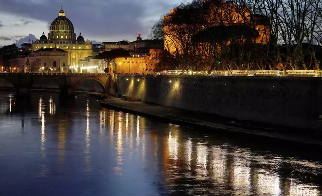 St Peter's Basilica at The Vatican at dusk across the river Tiber in Rome, Italy Friday, Feb. 28, 2025. (AP Photo/Kirsty Wigglesworth)