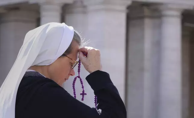 A nun prays at the Vatican at the time when Pope Francis would usually bestow his blessing, the Pontiff is currently recovering from a bilateral pneumonia at Rome's Agostino Gemelli Polyclinic, in Rome, Sunday, March 2, 2025. (AP Photo/Kirsty Wigglesworth)