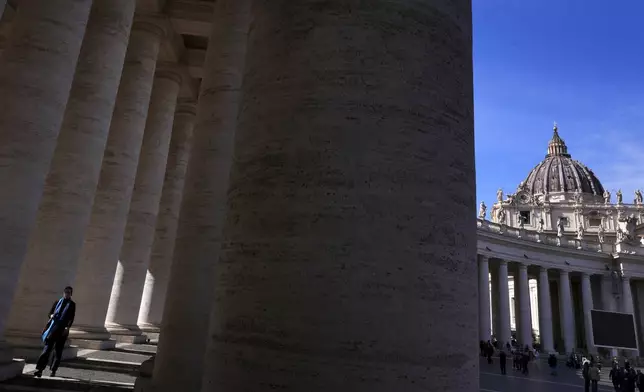 People walk through St Peter's Square at The Vatican, Sunday, March 2, 2025. (AP Photo/Kirsty Wigglesworth)