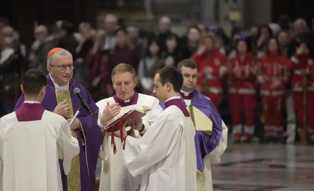 Vatican Secretary of State, Cardinal Pietro Parolin, left, delegated by Pope Francis who's being treated for pneumonia at Rome's Agostino Gemelli Polyclinic, presides over a mass with the pilgrims of the "Movement for Life" in St. Peter's Basilica at The vatican, Saturday, March 8, 2025. (AP Photo/Gregorio Borgia)