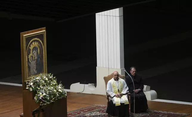 The Pope's vicar for the dioceses of Rome Cardinal Baldassarre Reina, left, during a rosary prayer held for the health of Pope Francis in St Peter's Square at The Vatican, Thursday, Feb. 27, 2025. (AP Photo/Kirsty Wigglesworth)
