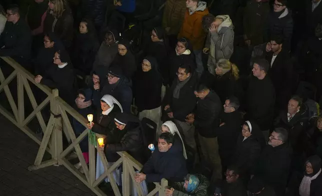 People attend a rosary prayer with Cardinal Victor Manuel Fernandez held for the health of Pope Francis in St Peter's Square at the Vatican, Friday, Feb. 28, 2025. (AP Photo/Andrew Medichini)