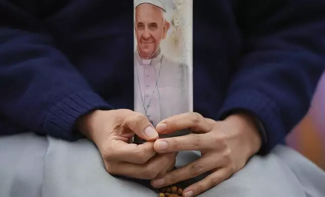 A nun prays for Pope Francis in front of the Agostino Gemelli Polyclinic, in Rome, Sunday, March 9, 2025. (AP Photo/Andrew Medichini)