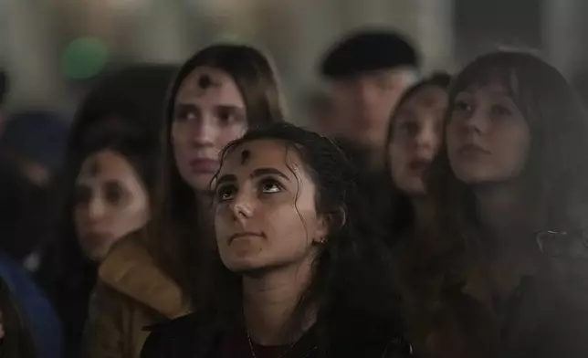 Girls, with ashes on their foreheads, pray during a rosary prayer for Pope Francis' health in St. Peter's Square at the Vatican, Wednesday, March 5, 2025. (AP Photo/Alessandra Tarantino)