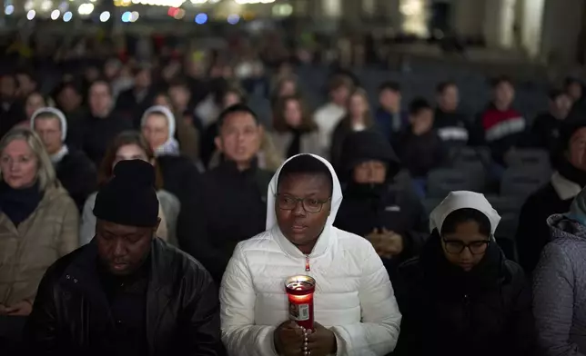 Catholic worshippers pray during a prayer of the Rosary for Pope Francis in St. Peter's Square at The Vatican, Thursday, March 6, 2025. (AP Photo/Francisco Seco)