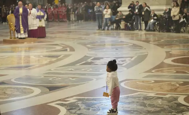A child follows Vatican Secretary of State, Cardinal Pietro Parolin, left background, delegated by Pope Francis who's being treated for pneumonia at Rome's Agostino Gemelli Polyclinic, presiding over a mass with the pilgrims of the "Movement for Life" in St. Peter's Basilica at The Vatican, Saturday, March 8, 2025. (AP Photo/Gregorio Borgia)