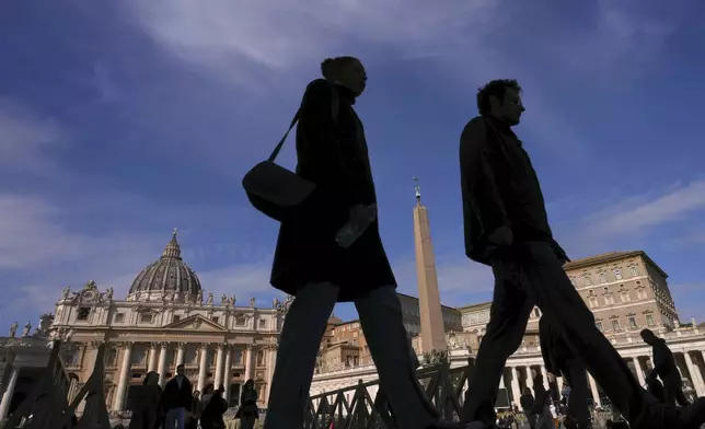 People walk through St. Peter's Square at The Vatican, Sunday, March 2, 2025. (AP Photo/Kirsty Wigglesworth)