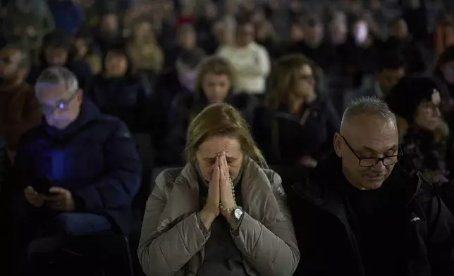 A woman prays as she joins with others for a prayer of the Rosary for Pope Francis in St. Peter's Square at The Vatican, Friday, March 7, 2025. (AP Photo/Francisco Seco)