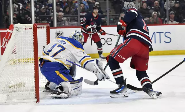Buffalo Sabres' goaltender James Reimer (47) makes a save on Winnipeg Jets' Gabriel Vilardi (13) during the second period of an NHL hockey game in Winnipeg, Manitoba, Sunday March 23, 2025. (Fred Greenslade/The Canadian Press via AP)