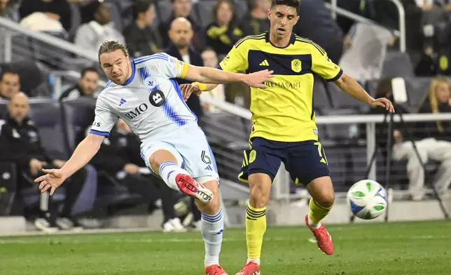 CF Montréal midfielder Samuel Piette (6) kicks the ball as Nashville SC midfielder Gastón Brugman (7) defends during the second half of an MLS soccer match Saturday, March 22, 2025, in Nashville, Tenn. (AP Photo/John Amis)