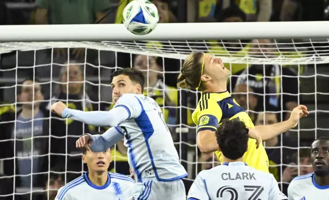 CF Montréal defender Luca Petrasso, left, and Nashville SC defender Walker Zimmerman, right, compete for a header during the first half of an MLS soccer match Saturday, March 22, 2025, in Nashville, Tenn. (AP Photo/John Amis)