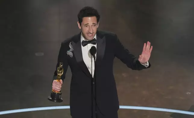 Adrien Brody accepts the award for best performance by an actor in a leading role for "The Brutalist" during the Oscars on Sunday, March 2, 2025, at the Dolby Theatre in Los Angeles. (AP Photo/Chris Pizzello)