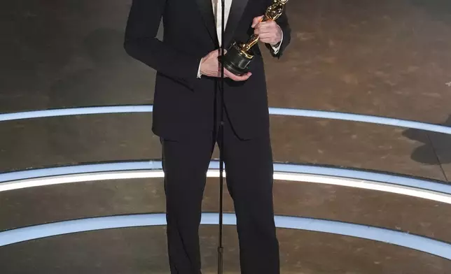 Adrien Brody accepts the award for best performance by an actor in a leading role for "The Brutalist" during the Oscars on Sunday, March 2, 2025, at the Dolby Theatre in Los Angeles. (AP Photo/Chris Pizzello)