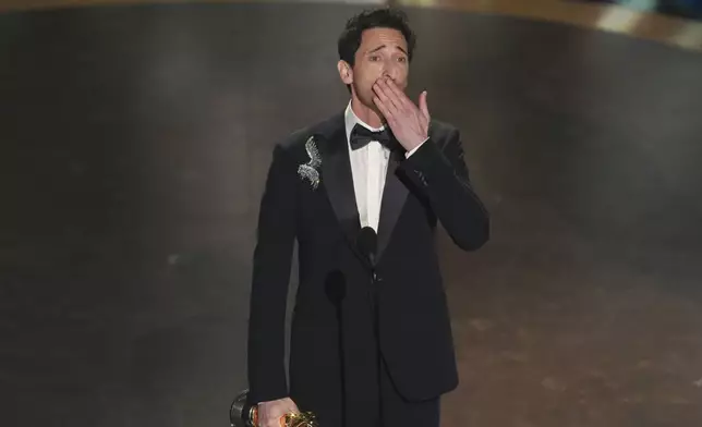 Adrien Brody accepts the award for best performance by an actor in a leading role for "The Brutalist" during the Oscars on Sunday, March 2, 2025, at the Dolby Theatre in Los Angeles. (AP Photo/Chris Pizzello)