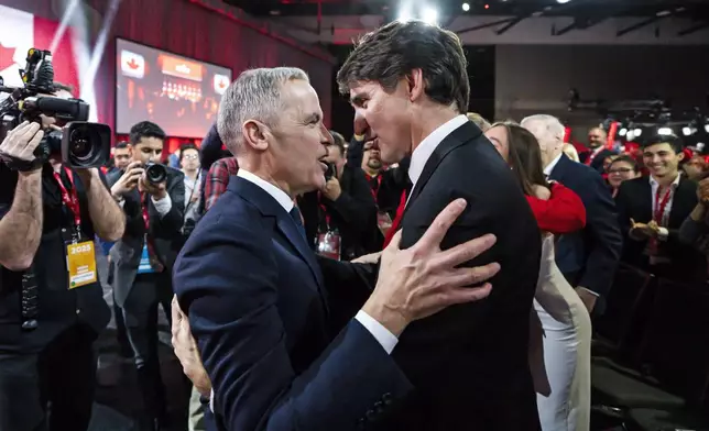 Mark Carney, Leader of the Liberal Party of Canada, embraces Prime Minister Justin Trudeau after being announced the winner at the Liberal leadership Event in Ottawa, Ontario, Sunday, March 9, 2025. (Justin Tang/The Canadian Press via AP)