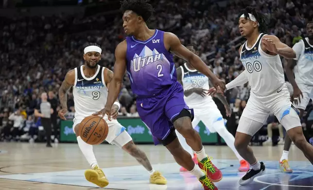 Utah Jazz guard Collin Sexton (2) dribbles during the first half of an NBA basketball game against the Minnesota Timberwolves, Sunday, March 16, 2025, in Minneapolis. (AP Photo/Abbie Parr)