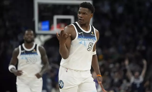 Minnesota Timberwolves guard Anthony Edwards (5) gestures after making a 3-point shot during the first half of an NBA basketball game against the Utah Jazz, Sunday, March 16, 2025, in Minneapolis. (AP Photo/Abbie Parr)