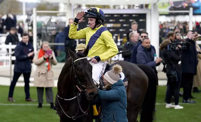 Jockey Sean Flanagan celebrates on Marine Nationale after winning the Queen Mother Champion Chase on day two of the 2025 Cheltenham Festival at Cheltenham Racecourse, England, Wednesday, March 12, 2025. (Andrew Matthews/PA via AP)