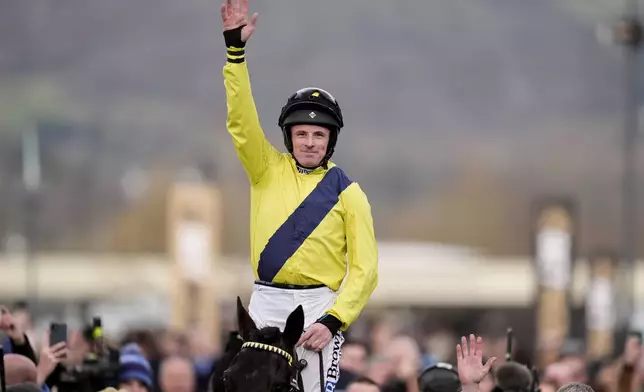 Jockey Sean Flanagan celebrates on Marine Nationale after winning the Queen Mother Champion Chase on day two of the 2025 Cheltenham Festival at Cheltenham Racecourse, England, Wednesday, March 12, 2025. (Andrew Matthews/PA via AP)