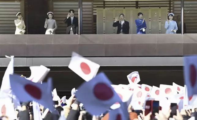 Japanese Emperor Naruhito, third right, accompanied by Empress Masako, second right, their daughter Princess Aiko, right, Crown Prince Akishino, Crown Princess Kiko, second left, and Princess Kako, waves to well-wishers from the balcony of the Imperial Palace in Tokyo on the emperor's 65th birthday, Sunday, Feb. 23, 2025. (Kyodo News via AP)