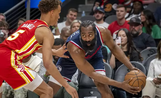 Los Angeles Clippers guard James Harden (1), right, attempts to pass the ball against Atlanta Hawks guard Dyson Daniels (5), left, during the first half of an NBA basketball game, Friday, March 14, 2025, in Atlanta. (AP Photo/Erik Rank)