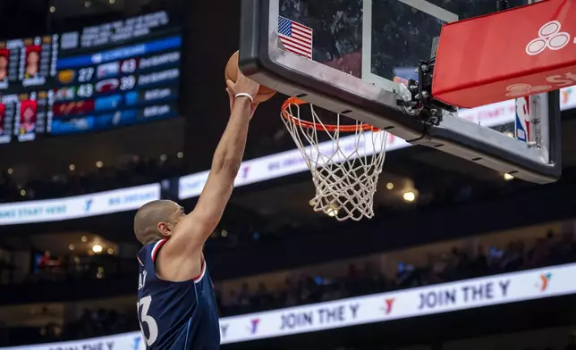 Los Angeles Clippers forward Nicolas Batum makes a slam dunk during the first half of an NBA basketball game against the Atlanta Hawks, Friday, March 14, 2025, in Atlanta. (AP Photo/Erik Rank)