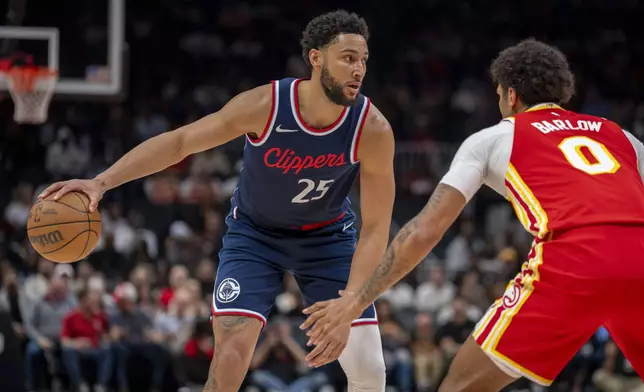 Los Angeles Clippers guard Ben Simmons (25), left, attempts to pass the ball against Atlanta Hawks forward Dominick Barlow (0), right, during the first half of an NBA basketball game, Friday, March 14, 2025, in Atlanta. (AP Photo/Erik Rank)