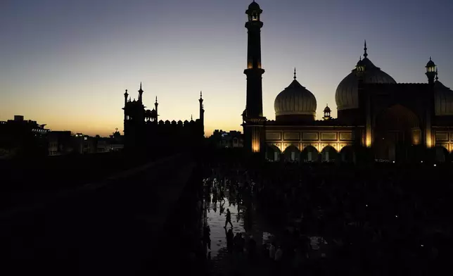 Devout Muslims leave after breaking their fast at sundown on the first day of Ramadan at Jama Masjid in New Delhi,India, Sunday, March, 2, 2025. (AP Photo/Manish Swarup)