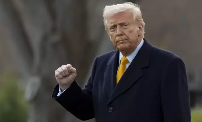 FILE - President Donald Trump pumps his fist before departing on Marine One from the South Lawn of the White House, Friday, March 7, 2025, in Washington. (AP Photo/Alex Brandon, File)