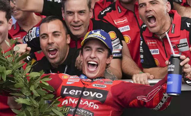 Spain's Marc Marquez of the Ducati Lenovo Team, center, celebrates winning the MotoGP race in Termas de Rio Hondo circuit, Argentina, Sunday, March 16, 2025. (AP Photo/Gustavo Garello)