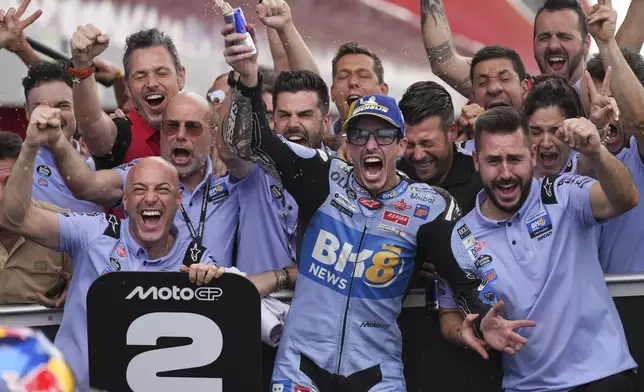 Spain's Alex Marquez of the BK8 Gresini Racing MotoGP Team, center, celebrates finishing second place at the MotoGP race in Termas de Rio Hondo circuit, Argentina, Sunday, March 16, 2025. (AP Photo/Gustavo Garello)