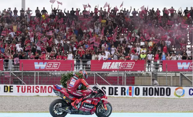 Spain's Marc Marquez of the Ducati Lenovo Team celebrates winning the MotoGP race in Termas de Rio Hondo circuit, Argentina, Sunday, March 16, 2025. (AP Photo/Gustavo Garello)