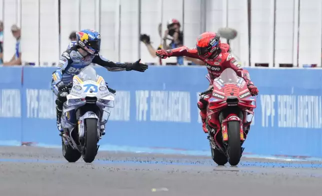 MotoGP race winner Spain's Marc Marquez of the Ducati Lenovo Team, right, celebrates with second place Spain's Alex Marquez of the BK8 Gresini Racing MotoGP Team in Termas de Rio Hondo circuit, Argentina, Sunday, March 16, 2025. (AP Photo/Gustavo Garello)