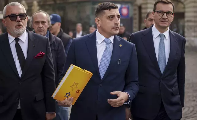 George Simion, the leader of Romania's most popular far-right party, the Alliance for the Union of Romanians (AUR), walks with former Polish Prime Minister Mateusz Morawiecki, right, in Bucharest, Romania, Friday, March 14, 2025, after filing his candidacy to participate in the country's presidential election rerun in May. (AP Photo/Vadim Ghirda)
